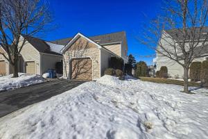a house with snow on the driveway at Northern Michigan Manistee Magic in Manistee