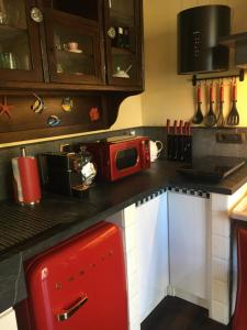a kitchen with a red microwave on a counter at Casa Rossa in Portovenere
