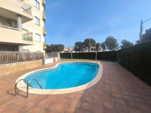 a swimming pool in front of a building at Sombrero in Miami Platja