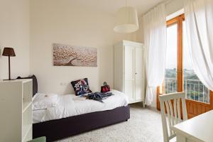 Un pat sau paturi într-o cameră la La casa dei nonni