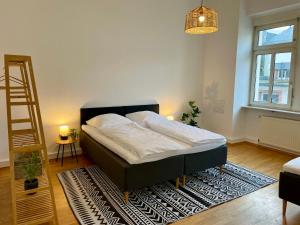 a bed in a room with a ladder and a rug at LaBed - Wohnen direkt an der Drosselgasse, stilvolle Ferienwohnung mit Rheinblick in Rüdesheim am Rhein