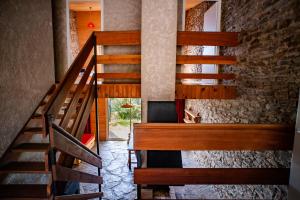 a staircase in a house with a stone wall at Village de vacances Le Serre de la Can in Saint-Germain-de-Calberte