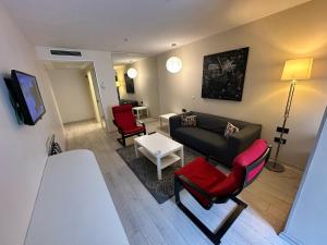 a living room with a couch and two chairs at Tempo Fair Suites in Istanbul