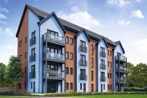 a large brick building with balconies on it at Luxury Riverside 2 bedroomed Apartment with Balcony in Newport