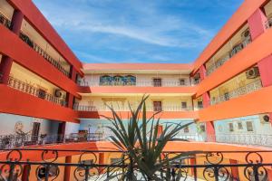 an apartment building with balconies and a plant at Studio 1Bed Room Apartment in Hurghada