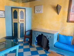 a living room with a couch and a fireplace at Hotel Sahara in Essaouira