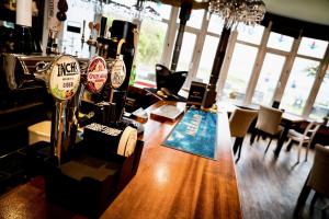 a bar with a wooden table in a room at The Brunswick in Shanklin