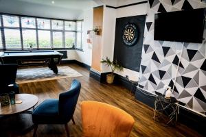 a living room with a pool table and a tv at The Brunswick in Shanklin +3 photos