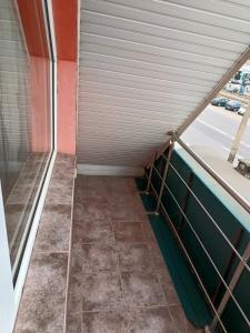 an empty corridor of a building with a window at Pensiunea Isabela in Craiova