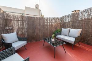 a patio with two chairs and a table at Hesperia Barcelona Barri Gòtic in Barcelona