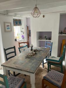 a dining room with a table and chairs at Cornish Cottage in Newquay