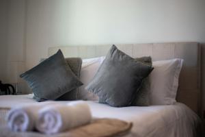 a bed with three pillows at Suite Jungle Studio with Views Walk Everywhere in Playa del Carmen