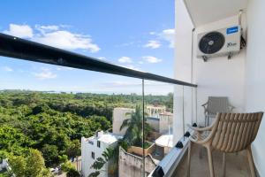 a balcony with a chair and a view at Suite Jungle Studio with Views Walk Everywhere in Playa del Carmen