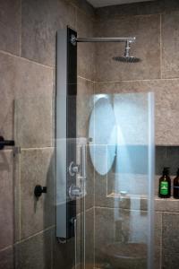 a shower with a glass door in a bathroom at Suite Jungle Studio with Views Walk Everywhere in Playa del Carmen
