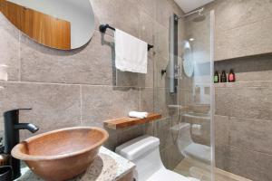 a bathroom with a wooden sink and a shower at Suite Jungle Studio with Views Walk Everywhere in Playa del Carmen