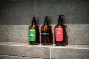three bottles of liquid soap sitting on a counter at Suite Jungle Studio with Views Walk Everywhere in Playa del Carmen