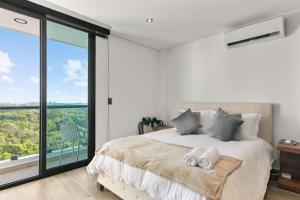 a bedroom with a bed and a large window at Suite Jungle Studio with Views Walk Everywhere in Playa del Carmen