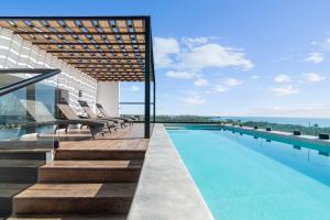 a swimming pool on the roof of a building at Suite Jungle Studio with Views Walk Everywhere in Playa del Carmen