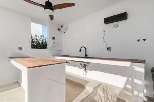 a kitchen with a sink and a ceiling fan at Suite Jungle Studio with Views Walk Everywhere in Playa del Carmen