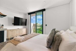 a bedroom with a large bed with a large window at Suite Jungle Studio with Views Walk Everywhere in Playa del Carmen