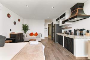 a kitchen and living room with a couch at Suite Jungle Studio with Views Walk Everywhere in Playa del Carmen