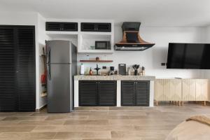 a kitchen with a refrigerator and a counter at Suite Jungle Studio with Views Walk Everywhere in Playa del Carmen
