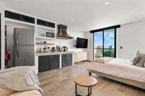 a living room with a bed and a refrigerator at Suite Jungle Studio with Views Walk Everywhere in Playa del Carmen +30 photos