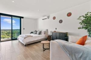 a living room with two beds and a couch at Suite Jungle Studio with Views Walk Everywhere in Playa del Carmen