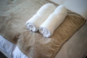 two towels are laying on a bed at Suite Jungle Studio with Views Walk Everywhere in Playa del Carmen