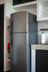 a stainless steel refrigerator in a kitchen at Suite Jungle Studio with Views Walk Everywhere in Playa del Carmen