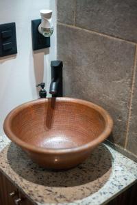 a wooden bowl sink on a counter in a bathroom at Suite Jungle Studio with Views Walk Everywhere in Playa del Carmen