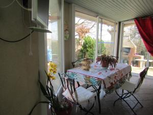 a table and chairs in a room with a window at Galinat in Culmont