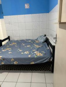 a bed with a blue blanket with animals on it at Yellow house 1 in Salvador