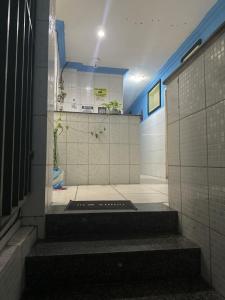 a bathroom with stairs in a room with tiles at Yellow house 1 in Salvador