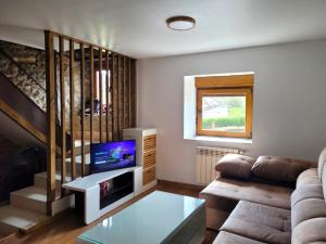 a living room with a couch and a tv at Casa Verana en Asturias VV-3421-AS in Granda