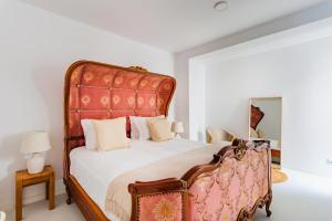 a bedroom with a large bed with a red headboard at Mbird Estoril Riviera Flat 3 in Estoril +47 photos