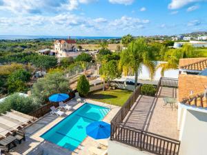 a view of the pool from the balcony of a house at Villa Sunlove in Peyia