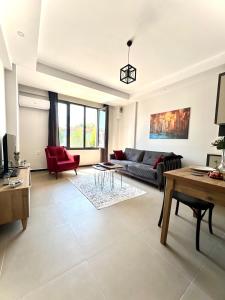 a living room with a couch and a table at Dalaman Ege Pam Residence in Dalaman
