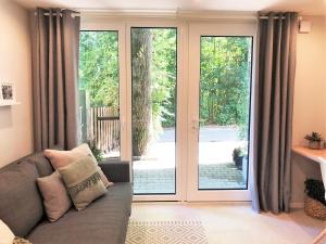 a living room with a couch and a sliding glass door at Lifestyle Apartment in Schwabach
