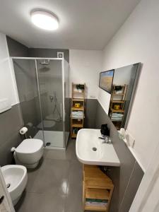 a bathroom with a toilet and a sink and a shower at Casetta di Chri in Chiavari +40 photos