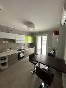 a kitchen with a table and chairs in it at Casa vacanza relax in Ortona