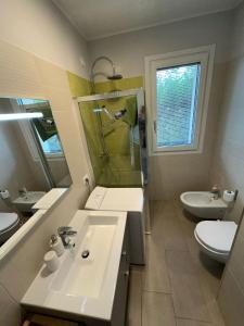 a bathroom with a sink and a shower and a toilet at Casa vacanza relax in Ortona