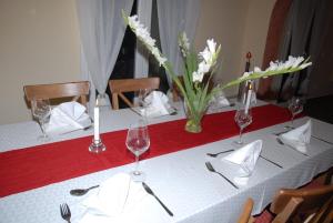 a table with wine glasses and a vase of flowers at Villa Chloe with Private Heated pool in Áfra