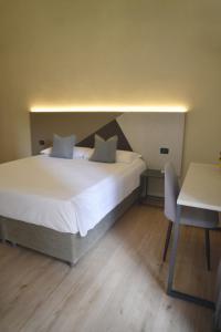 Postel nebo postele na pokoji v ubytování Hotel Torino