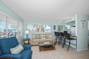 una sala de estar con un sofá y una mesa en Crescent Shore 201 by Sun Palace Vacations, en Fort Myers Beach
