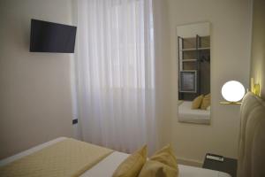 Postel nebo postele na pokoji v ubytování Hotel Torino