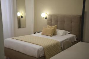 Postel nebo postele na pokoji v ubytování Hotel Torino