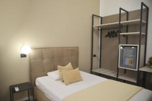Postel nebo postele na pokoji v ubytování Hotel Torino