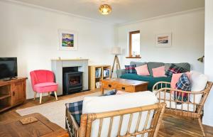 a living room with a couch and a tv at Lochside in Dornie