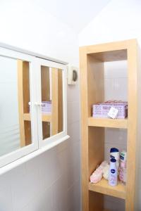 a bathroom with a medicine cabinet and a window at Miner's Retreat Comfy 2-Bed Home, Swadlincote in Woodville +43 photos